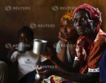 HIV-positive members of a self-help group meet with a caregiver in the village of Michelo, south of the Chikuni Mission in the south of Zambia, February 23, 2015. PHOTO BY REUTERS/Darrin Zammit Lupi