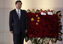 China's President Xi Jinping stands next to a flower arrangement depicting China's national flag during a ceremony at the National Pantheon in Caracas, July 20, 2014. PHOTO BY REUTERS/Carlos Garcia Rawlins