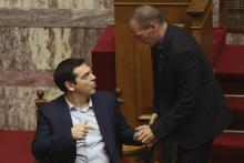 Greece's new leftist finance minister Yanis Varoufakis (R) talks with Greek Prime Minister Alexis Tsipras in the parliament in Athens, February 6, 2015. PHOTO BY REUTERS/Panayiotis Tzamaros
